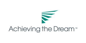Logo of "Achieving the Dream" featuring turquoise geometric shapes resembling a stylized arrow above the text.