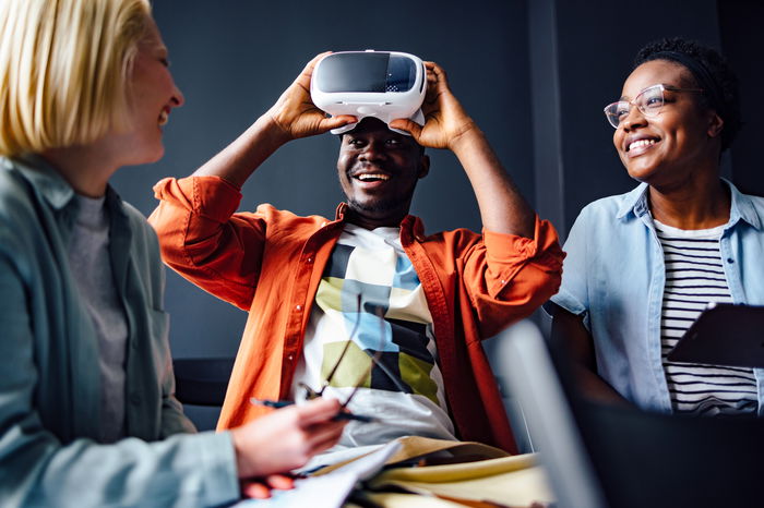 Friends having fun with a virtual reality headset.